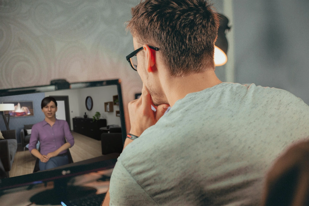 A man is interacting with an avatar in a Mursion practice session.